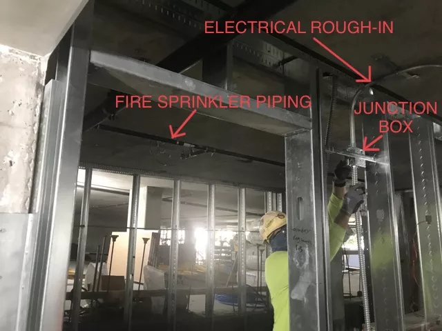 rough-in can begin once the frames of a building have been installed in the photo you can see that the metal studs have been put up indicating it's a good time to begin rough-in